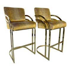 a pair of modern style barstools with gold upholstered fabric