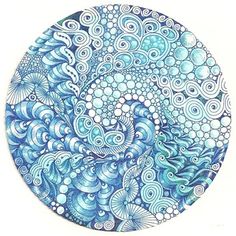 a blue and white drawing of an ocean wave with bubbles in the water on a circular plate