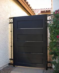 a black gate is in front of a house