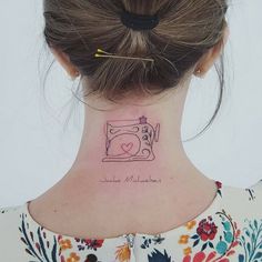 a woman with a sewing machine tattoo on her neck