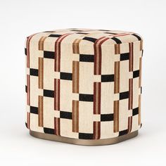 a stool made out of woven material with geometric designs on the top and bottom, sitting in front of a white background