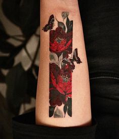 a woman's arm with flowers and butterflies on it