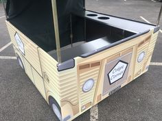 a cardboard box shaped like a camper with the door open and it's canopy closed