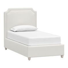 a bed with white linens and pillows on it's headboard, in front of a white background