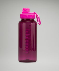 a purple water bottle with a pink lid on a gray background and the words ummelon printed on it