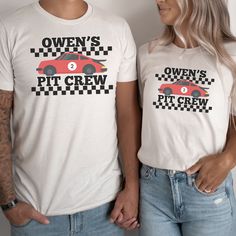 a man and woman standing next to each other wearing t - shirts with cars on them