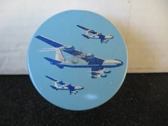 a blue and white plate with two airplanes on it