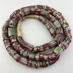 "A long strand of old Venetian trade beads. This is a bit bigger than the most usual 11mm diameter bead. The beads are in good condition.  67 bead 35\" of beads 90cm 38\" with raffia 13-16mm diameter 2mm hole" Antique Round Spacer Beads, Traditional Rondelle Single Strand Beads, Traditional Single Strand Rondelle Beads, Antique Hand-strung Oval Beads, Hand-strung Antique Oval Beads, African Trade Beads, Trade Beads, Seattle, Beauty Book