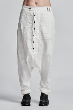 "Off-White Drop Crotch Boiled Linen Trousers with Buttons__ // EXPRESS DELIVERY ONLY __Semi Visible Front Closure with Black Buttons __3 Front & 2 Back Pockets __Fully Completed Bound Seams __Elastic Backside Waistband model__ bust 92 (36\"), waist 72 (28\"), hips 102 (40\"), biceps 28 (11''), height 177 (5'8\"), kg 65 (143 lbs) model wears size M | color: off-white fabric__ 100 linen care__ dry cleaning do not bleach do not tumble dry do not iron to keep wrinkle effect sizing__ size XS (US White Cotton Parachute Pants With Belt Loops, White Straight Leg Pants With Button Closure, White Cotton Tapered Leg Harem Pants, White Parachute Pants With Tapered Leg, White Parachute Pants With Tapered Legs, Fitted White Harem Pants With Pockets, White Cotton Harem Pants With Pockets, Baggy Tapered Pants With Button Closure, Fitted White Cotton Parachute Pants