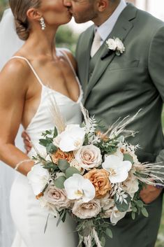 a bride and groom kissing each other