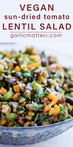 a bowl filled with lentils and vegetables on top of a white countertop next to the words vegan sun dried tomato lentil salad