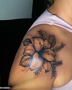 a woman with a flower tattoo on her shoulder