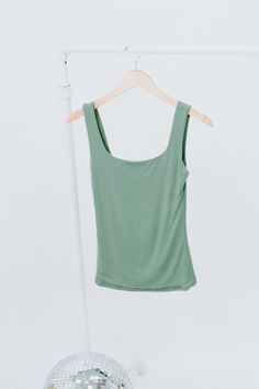 The Double Layered Reg Length Tank is a must-have for a casual summer wardrobe, offering the best basics with its double-layered design that adds a touch of uniqueness to a cute and solid shirt. This stylish and lightweight tank effortlessly embodies a summer aesthetic. Double Layered Tee Fixed straps Premium ribbed knit fabrication Fit: Fitted; Generous stretch Fabric: 92% Nylon 8% Spandex Model Specs: Emily + Karli are wearing a size small in the photo.How will this item fit you? Check out our Versatile Tank Top For Summer Loungewear, Versatile Seamless Tops For Day Out, Casual Green Solid Color Tank Top, Summer Stretch Tops With Seamless Design, Seamless Stretch Summer Tops, Versatile Tank Top For Spring Loungewear, Summer Stretch Seamless Tops, Basic Green Tank Top For Spring, Basic Green Tank Top For Summer