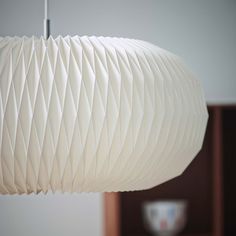 a white lamp hanging from a ceiling in a room