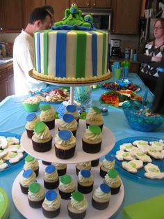 a cake and cupcakes are on a table