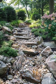 a garden with rocks and water running through it