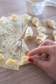 a person is cutting up some food on a table