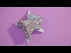 an origami star on a purple background