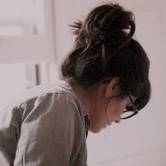 a woman sitting on the floor in front of a laptop computer