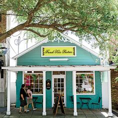 two people are standing in front of a store