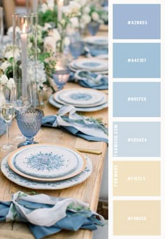 the table is set with blue and white plates, silverware, candles, and flowers