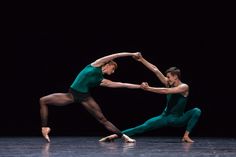 two ballet dancers in green and black outfits