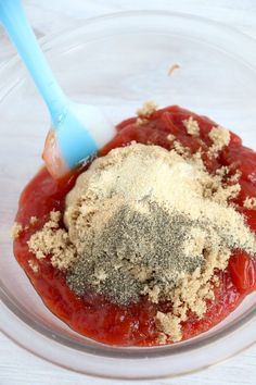 a bowl filled with spices and seasoning on top of a table