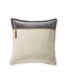 a gray and white pillow with a zipper on the front, along with a black border