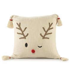 a white pillow with reindeer antlers on it's face and tasselled ears