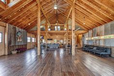 the inside of a large wooden building with wood floors and walls, along with high vaulted ceilings