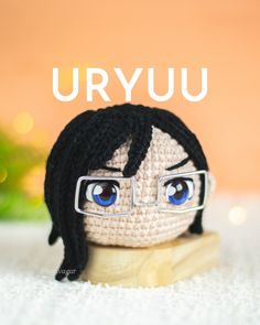 a crocheted doll with glasses on it's head and the words uryju above it