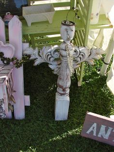 an assortment of painted wooden furniture on the grass in front of a bench and chair