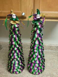 two decorated bottles sitting on top of a counter