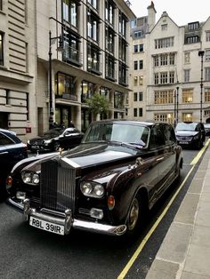 a black car parked on the side of a street