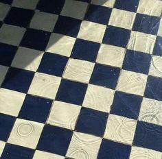 a black and white checkered floor with water on it