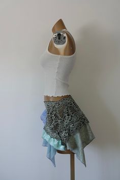 One of a Kind Size Small/Medium Elastic lace waistband Hand draped skirt Synthetic spandex fabric Mid-Low waist Model is 5’8, 32A Bust, Waist 26, Hips 38.5 Sizing Measurements in Inches Below Waist 26-28”, Hips 36-41”, Inseam Length 16” Up-cycled from two shirts, thrifted fabric, and a skirt *these skirts are all handmade and hand draped (not patterned) the prices reflect the time it took to create them. We try and price them as fairly as possible. You aren’t just purchasing a skirt you are purc Fitted Bottoms With Lace Patchwork For Summer, Stretch Lace Trim Skirt, Fitted Summer Bottoms With Lace Patchwork, Asymmetrical Lace Skirt With Lace Trim, Fitted Lace Patchwork Skirt, Lace Asymmetrical Skirt With Lace Trim, Asymmetrical Lace Flowy Skirt, Lace Trim Asymmetrical Skirt, Lace Skirt With Ruffles And Stretch