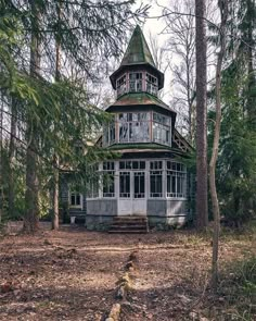 an old house in the woods surrounded by trees