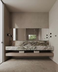 a bathroom with marble counter tops and mirrors