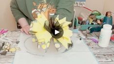 a person is making a flower out of paper