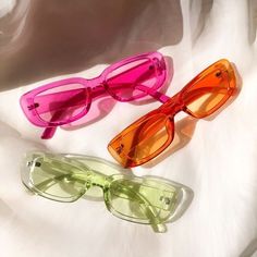 photo of three pairs of unglazed in pink, green, and yellow. Pretty Sunglasses, Sunglasses Aesthetic, Popular Sunglasses, Funky Glasses, Chic Sunglasses