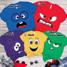 four different colored shirts with faces on them