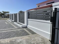 a black and white fence next to a building