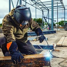 a man welding steel in an industrial setting