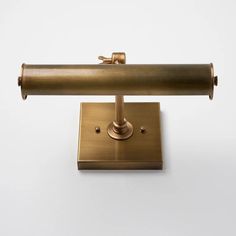 an antique brass desk lamp on a white background