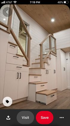 the stairs in this room are made from wood and have drawers on each one side