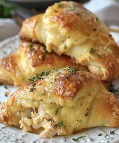 two pastries on a white plate with parsley