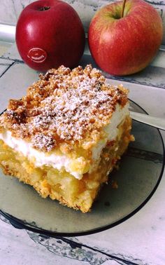 a piece of cake on a plate next to an apple