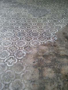 an old cement floor with white designs on it