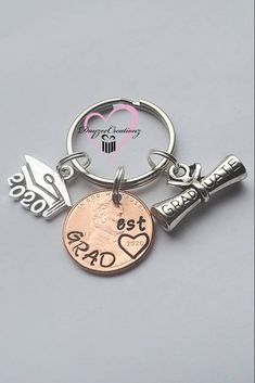 a keychain with two charms and a coin on it that says best dad