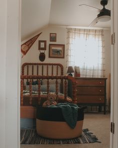 Vintage style little boys room with a rag rug, green dresser, vintage art, and plaid curtains Vintage Farm Bedroom, Christopher Robin Bedroom, Board And Button With Wallpaper, Farmhouse Toddler Boy Room, Thrifted Kids Room, Antique Kids Room, Vintage Boys Room Decor, Cottagecore Boys Room, Antique Boys Room